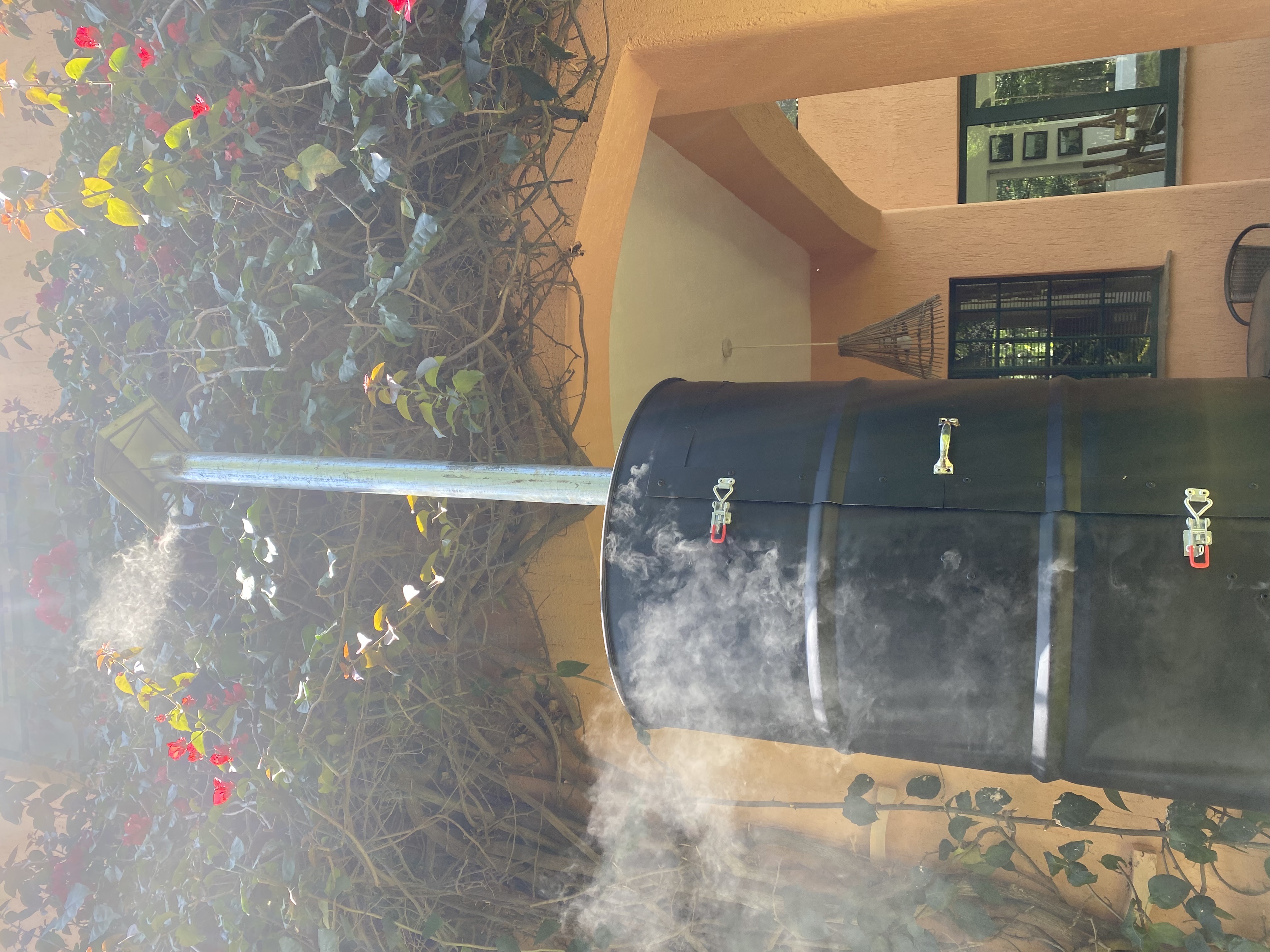 Smoke rising from the Red Thorn smoker during the week's batch